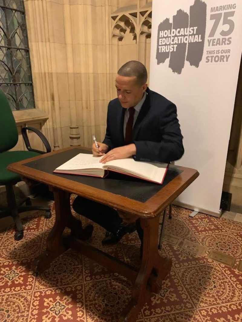 Clive signs the Holocaust Memorial Day book in parliament