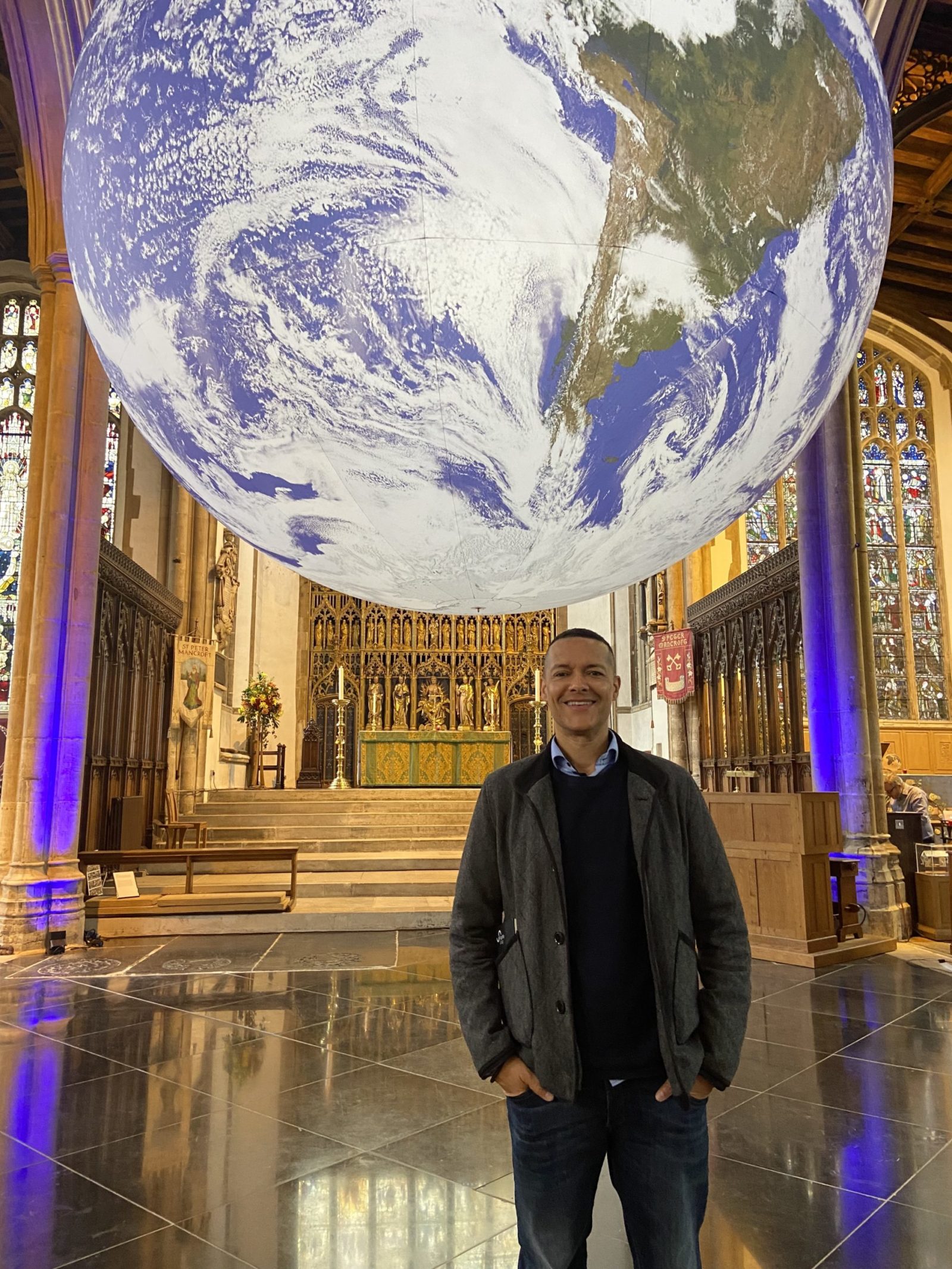 Image shows Clive in St Peter Mancroft with the Gaia Art installation behind him. 